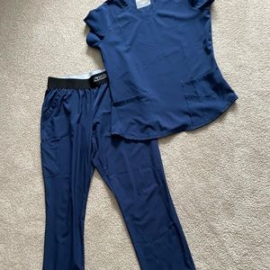 Navy sketchers scrub set. Top is a medium. Bottom is large. Selling as a set.